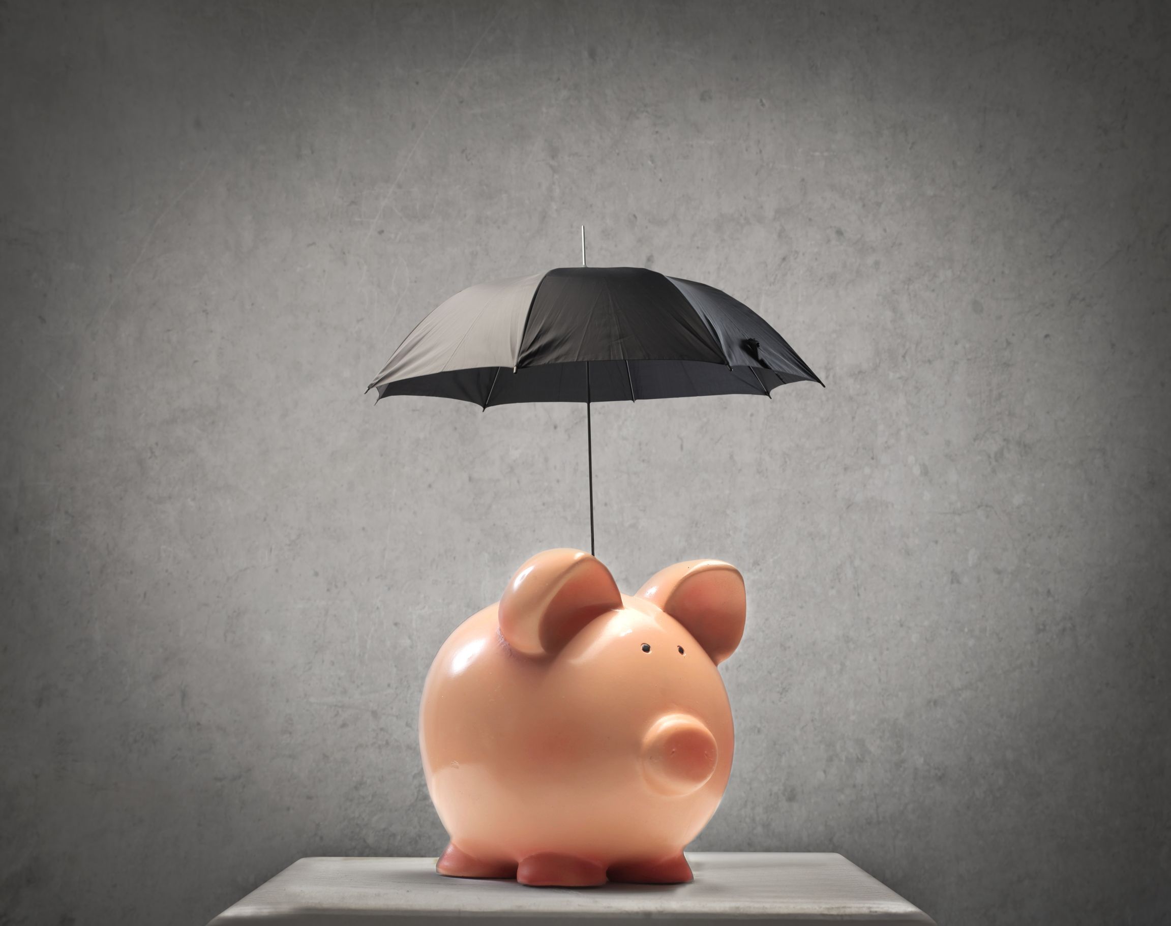 15942476_l-Piggy-protecting-itself-with-a-little-black-umbrella-insurance-saving-concept