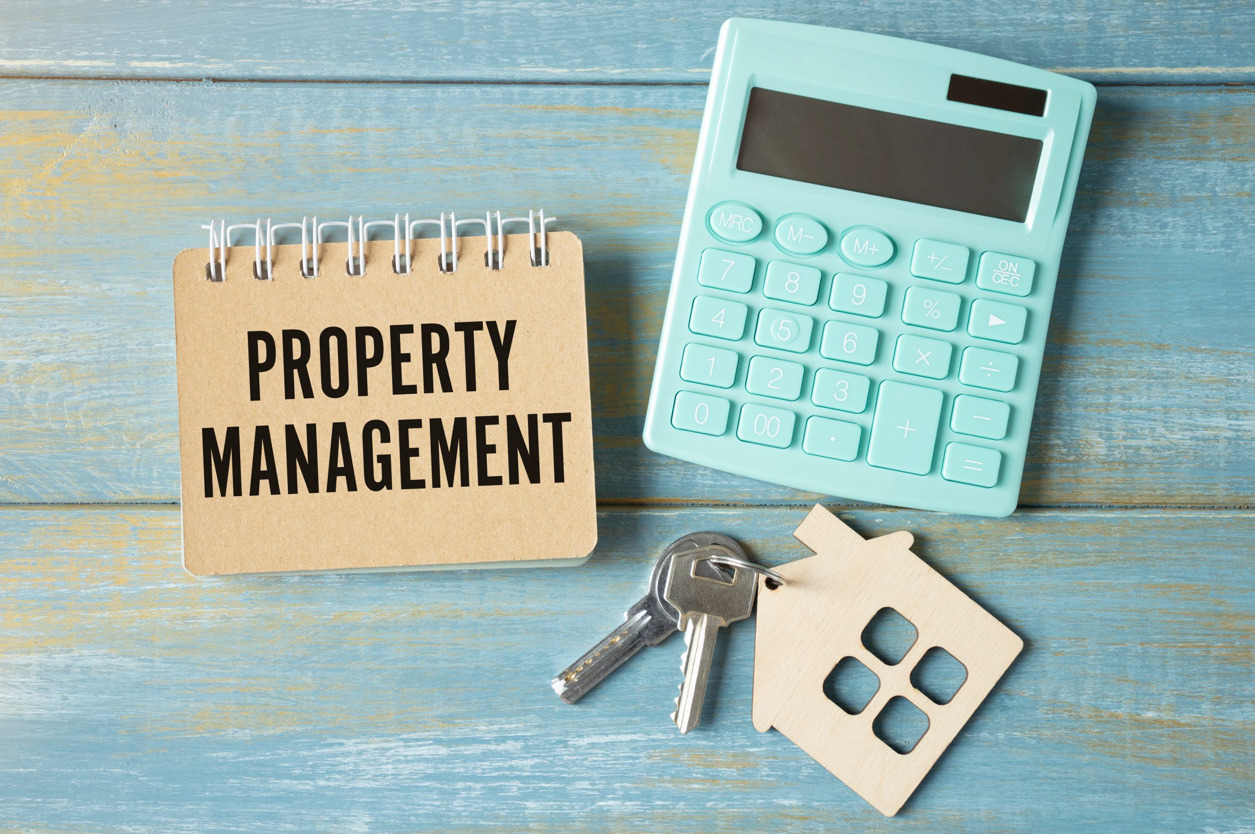 Text Property Management is on the white paper with calculator and the keys.